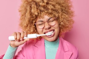 Woman using electric toothbrush